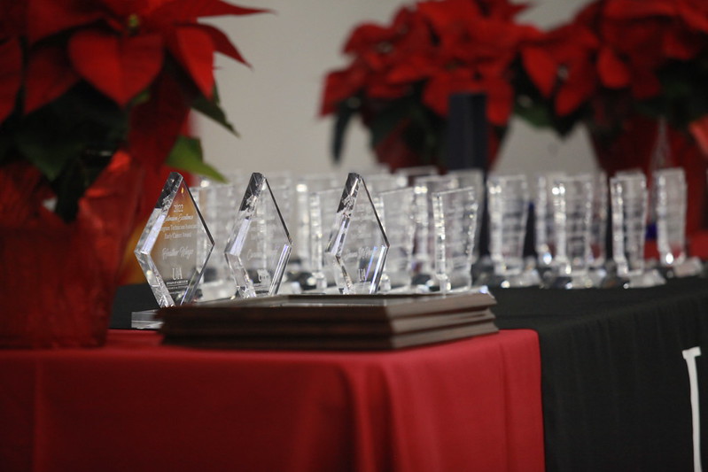 Image of trophies and flowers on a table.