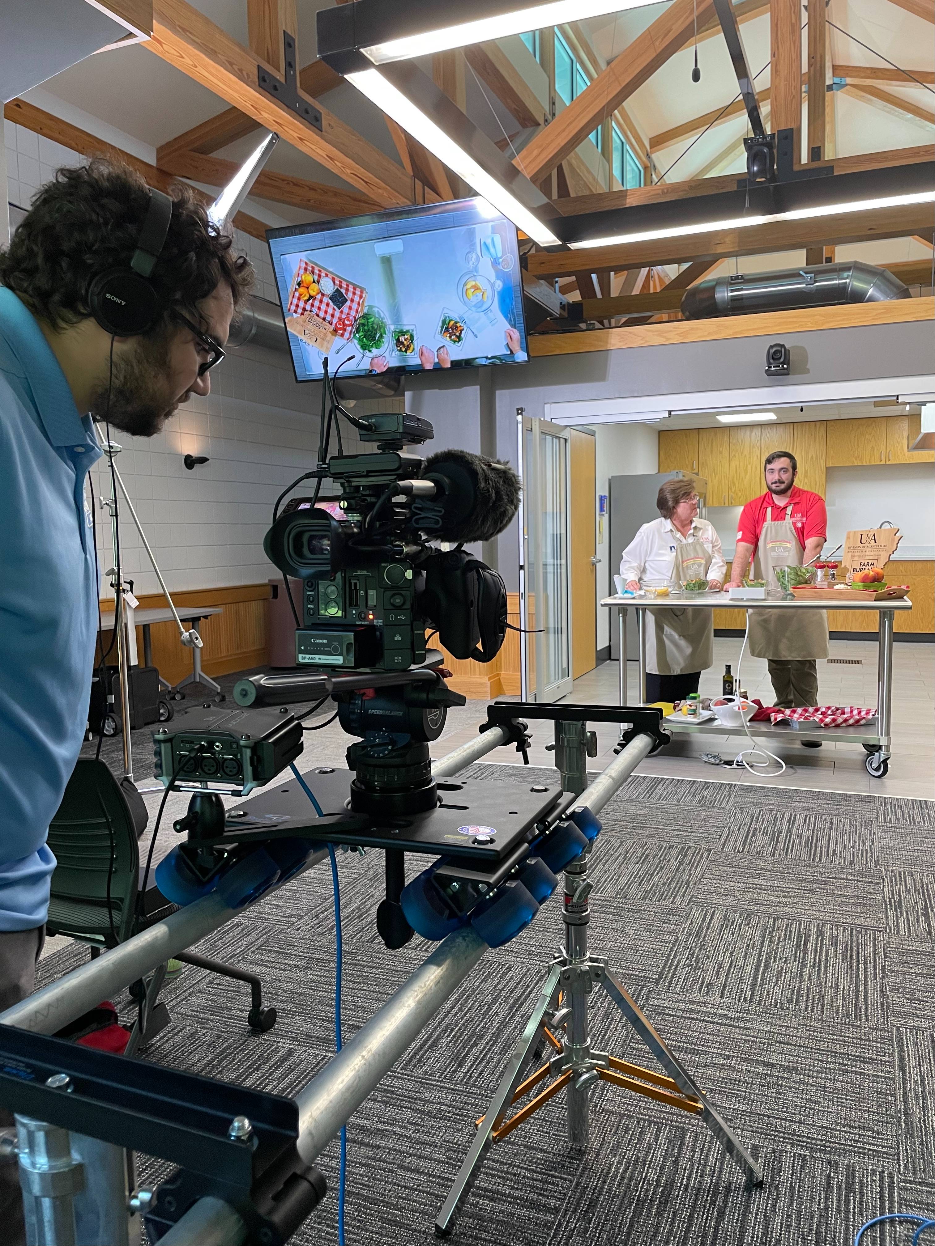 A videographer looks a camera in the set of Arkansas Home Grown & Homemade